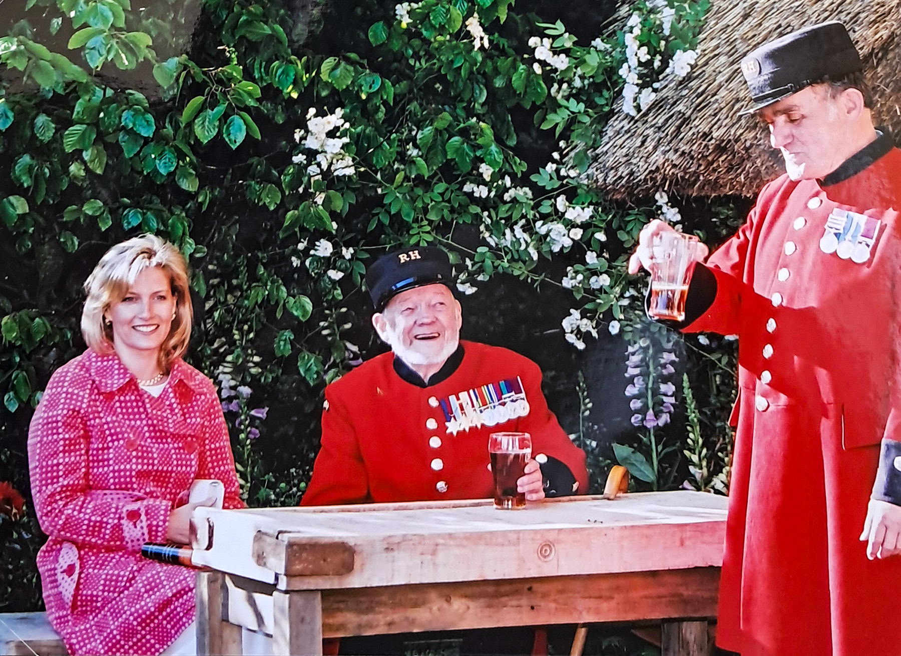 The then Royal Highness The Countess of Wessex sits with Chelsea Pensioners in the Soldier's Dream of Blighty Garden at the Chelsea Flower Show 2005