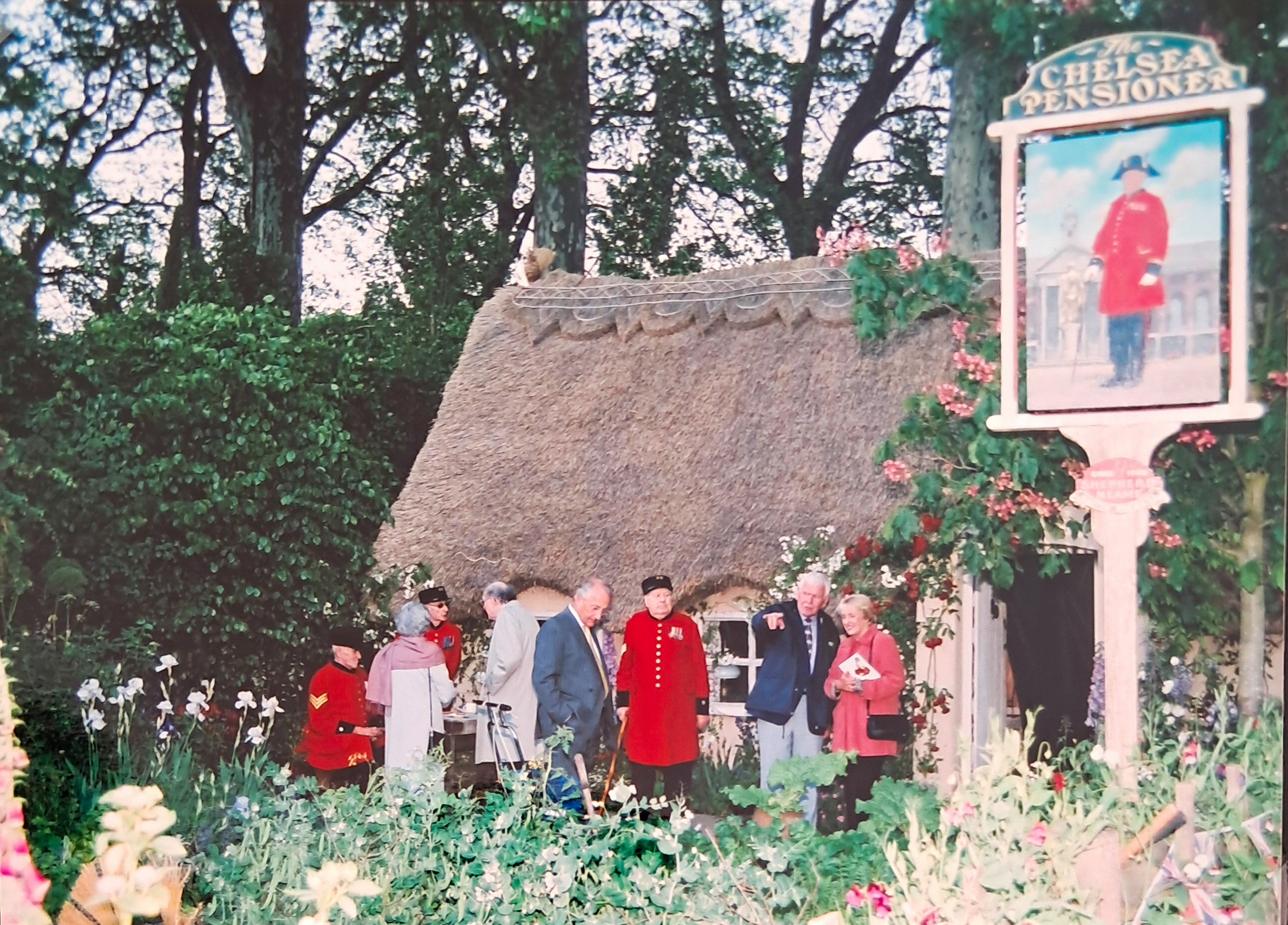 Pensioners and guests gather at the Chelsea Flower Show at the best in show garden A Soldiers Dream of Blighty