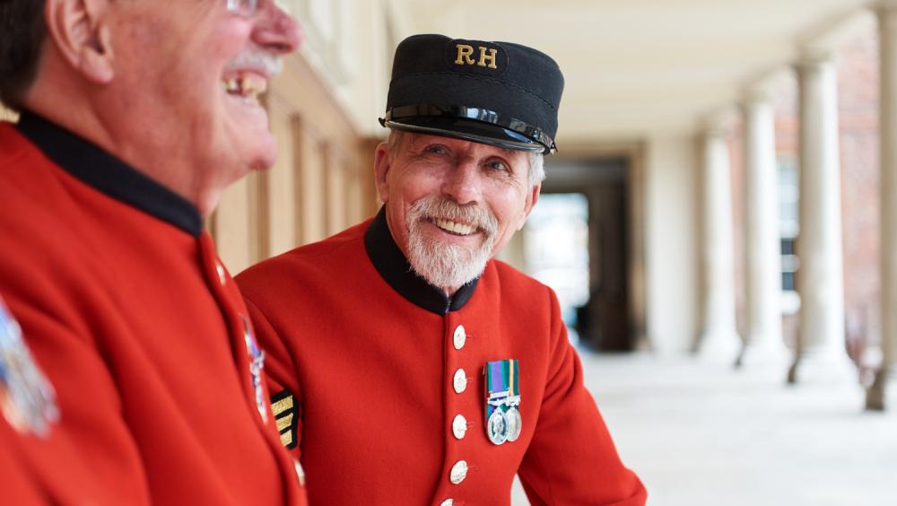 Chelsea Pensioners sitting in the colonnade overlooking Figure Court